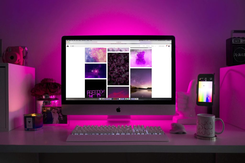 computer on desk with purple background computer on desk with purple background